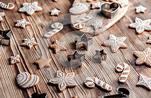 Set of homemade gingerbread on brown wooden background. Christmas cookies in stars shape.