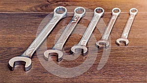 Set of horn and socket wrenches on a wooden background