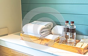 A set of hotel toiletries with white clean towel in a bathroom