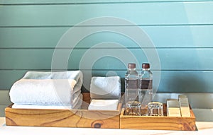 A set of hotel toiletries with white clean towel in a bathroom