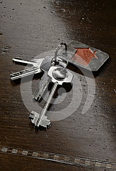 Set of house keys on brown wooden table