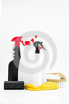 Set of household chemicals for cleaning on a white background. washcloth, bottles with detergents close-up.