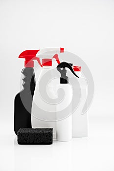 Set of household chemicals for cleaning on a white background. washcloth, bottles with detergents close-up.