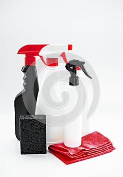 Set of household chemicals for cleaning on a white background. washcloth, gloves, bottles with detergents close-up.