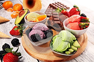 Set of ice cream scoops of different colors and flavours with berries, chocolate and fruits