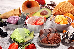 Set of ice cream scoops of different colors and flavours with berries, chocolate and fruits