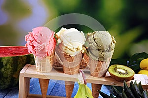 Set of ice cream scoops of different colors and flavours with berries and fruits