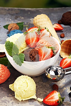 Set of ice cream scoops of different colors and flavours with berries and fruits