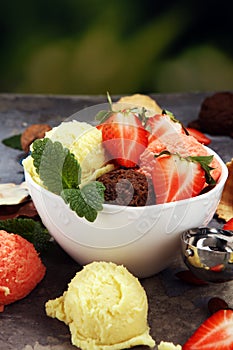 Set of ice cream scoops of different colors and flavours with berries and fruits