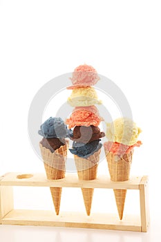 Set of ice cream scoops of different colors and flavours with berries and fruits