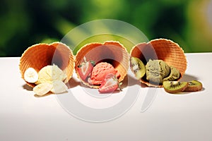 Set of ice cream scoops of different colors and flavours with berries and fruits