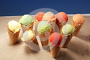 Set of ice cream scoops of different colors and flavours with berries and fruits