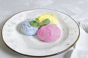 Set of ice cream scoops of different colors and flavours with berries, nuts and fruits