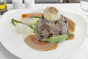 Set inflight meal steak on a tray, on a white table