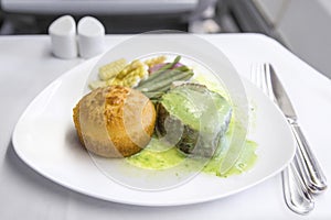 Set inflight meal steak on a tray, on a white table photo