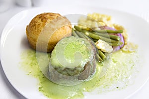 Set inflight meal steak on a tray, on a white table