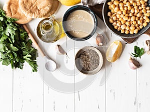 Set of ingredients for cooking homemade traditional hummus on a white wood background. Top view