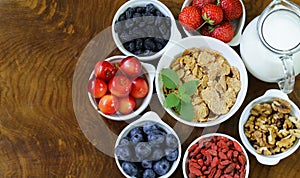 Set of ingredients for a healthy food breakfast - muesli, fresh and dried fruit, nuts, goji