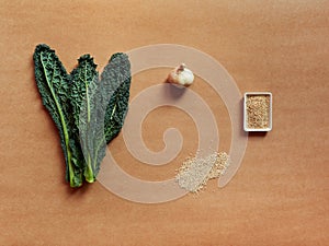 Set of ingredients for kale recipe, ail, seasame seeds, and ail photo