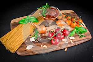 Set of ingredients for vegetarian pasta bolognes cherry tomatoes basil, pasta onions garlic tomatoes sauce