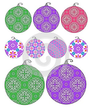 Set of isolated Christmas decorations holiday ornaments in different sizes with fancy ornate patterns in green, purple, and pink