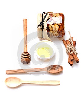 Set of jar with nuts, honey, wooden cutlery and cinnamon.