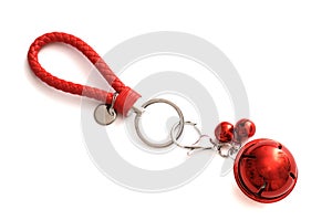 A set of keychains with red loop and red bell attached photo