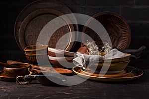 Set of kitchen ceramic and wooden tableware a table