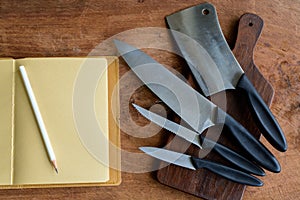 Set of kitchen knifes on wooden cutting board