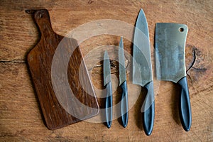 Set of kitchen knifes on wooden cutting board