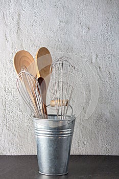 Set of kitchen utensil store in a tin in front view