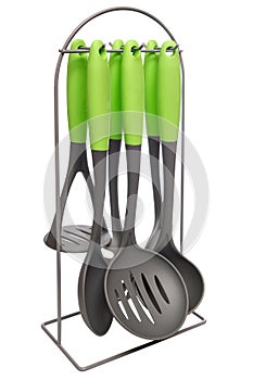 Set of kitchen utensils on a stand isolated on white background