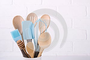Set of kitchen utensils, wooden and silicone, free copy space .