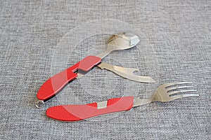 Set of knife, fork and travel spoon with red grip