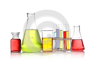 Set of lab glassware with color liquids isolated on white.