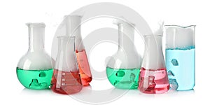 Set of laboratory flasks and beaker with colorful liquids on white background. Chemical reaction