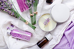 Set lavender skincare cosmetics products. Natural spa beauty products fresh lavender flowers on fabric. Lavender essential oil