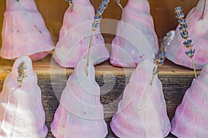 Set of lavender soap with natural lavender sticks on wooden shelf