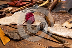 Set of leather craftsmen skinning with fur, awl and thread, selective focus