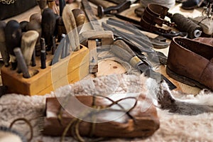 Set of leather working tools on working desk