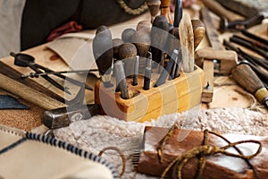 Set of leather working tools on working desk