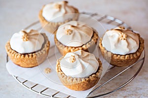 Set of lemon curd tartlets with whipped meringue. Close up