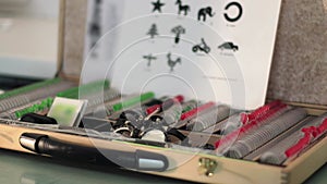 Set of lenses and ophthalmologist's instruments with Russian Baby Eye chart optotype for measure visual acuity