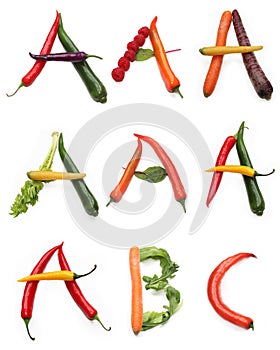 set of letter a b c made from green orange red purple chili pepper, carrots, green salad lettuce leaves and red raspberry