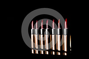 Set of lipsticks on black background.