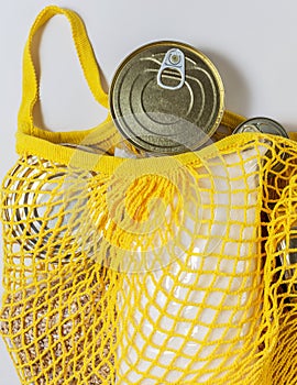A set of long-term storage products in a string bag on a white background. Food donations