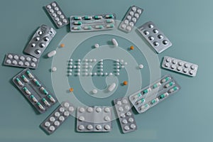 Set of loose pills and complete tablets on green glass table