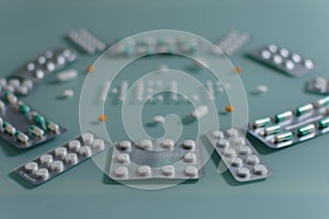 Set of loose pills and complete tablets on green glass table