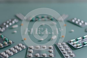 Set of loose pills and complete tablets on green glass table