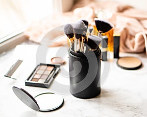 Set of luxurious black makeup brushes in leather case